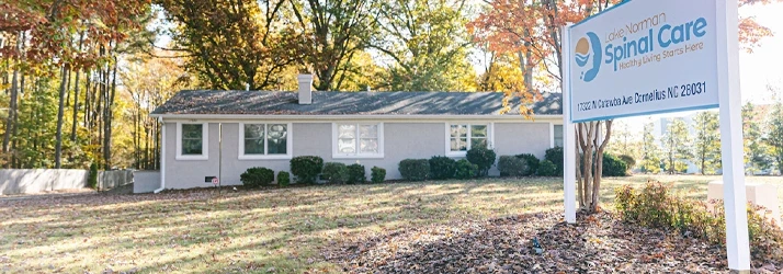 Exterior of Lake Norman Spinal Care clinic with branded roadside sign