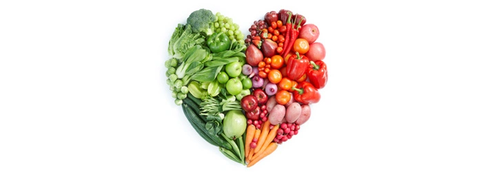 Heart shape made from assorted green and red fruits and vegetables