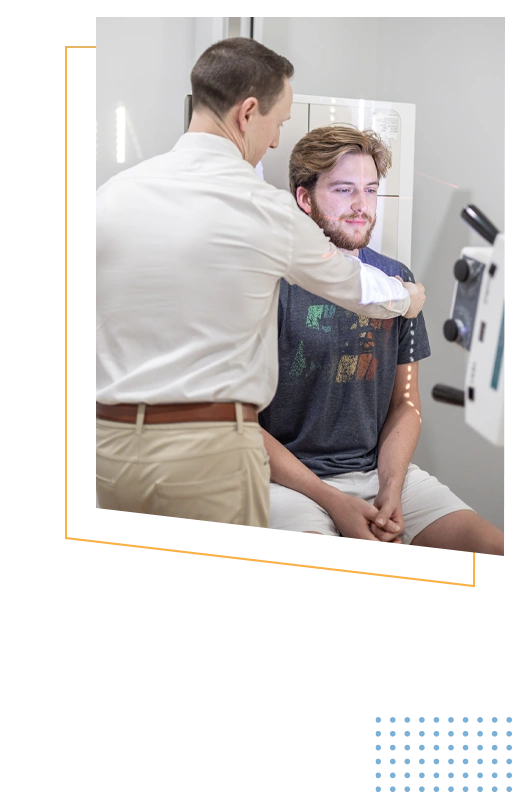 Dr. Jordan Barker positioning a patient for spinal imaging assessment