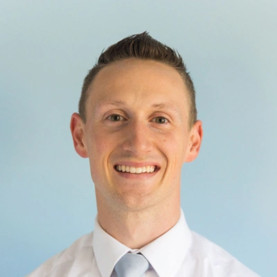 Dr. Jordan Barker against a light blue background